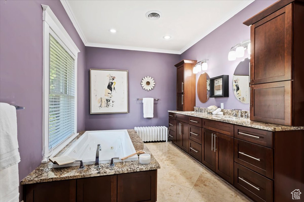 Bathroom with tile patterned flooring, a tub to relax in, ornamental molding, vanity, and radiator