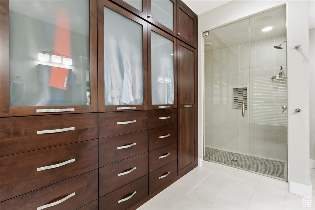 Bathroom featuring tile patterned flooring and a shower with shower door