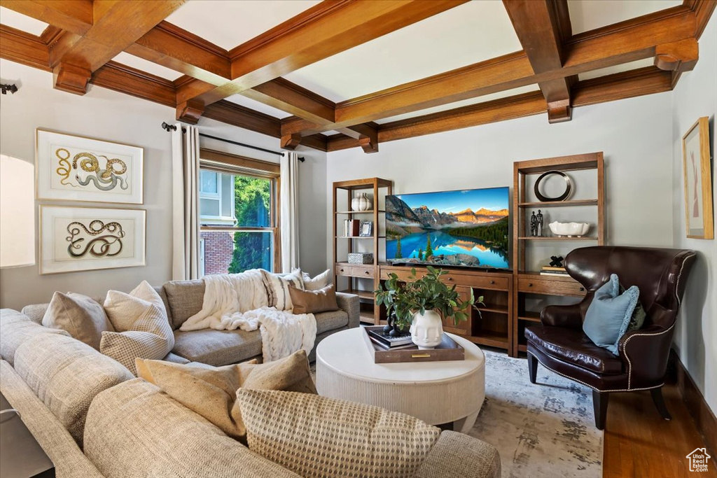 Living room featuring coffered ceiling, beamed ceiling, and hardwood / wood-style floors