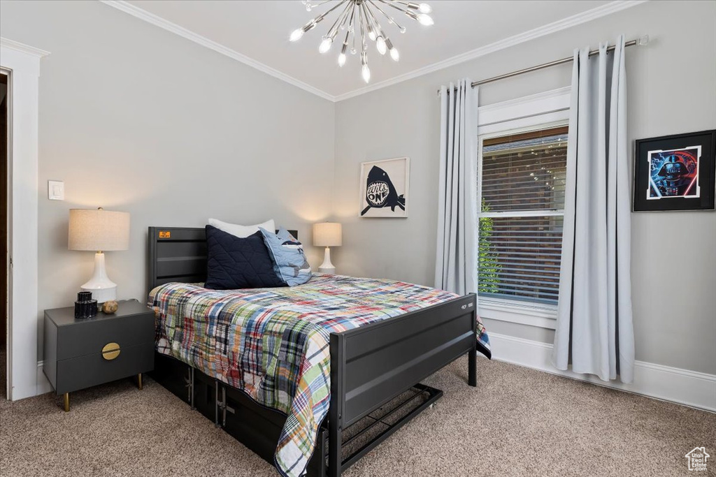 Bedroom featuring carpet flooring, an inviting chandelier, and ornamental molding