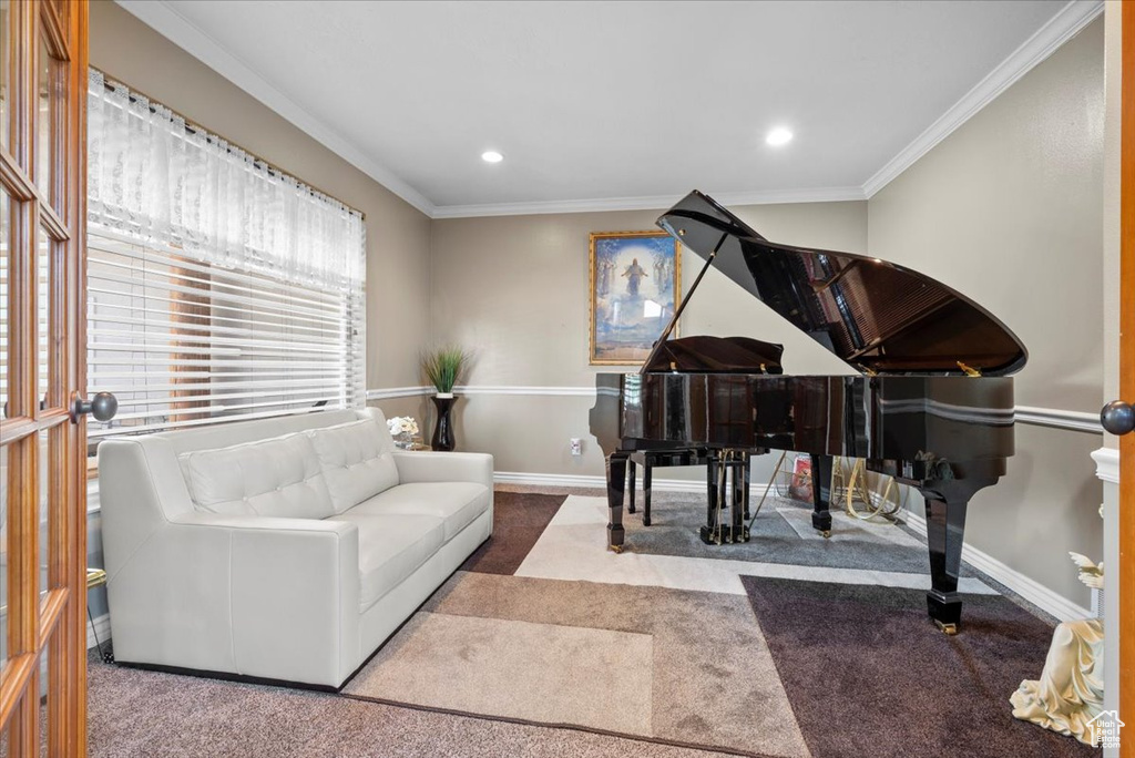 Living area with ornamental molding and carpet floors