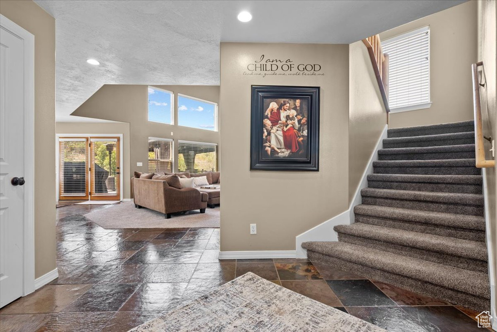 Stairs featuring dark tile patterned floors