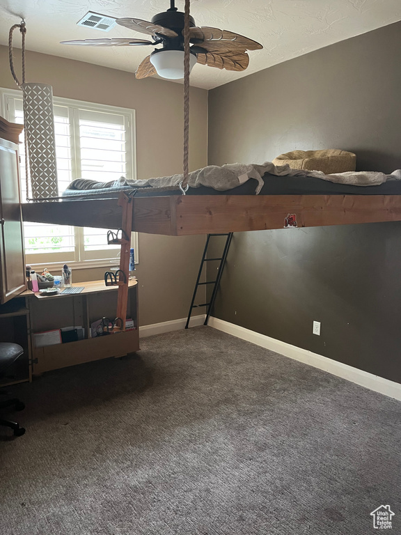 Bedroom featuring a ceiling fan, baseboards, visible vents, and carpet floors