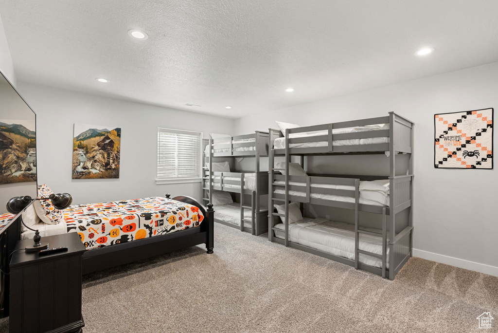 Carpeted bedroom featuring a textured ceiling