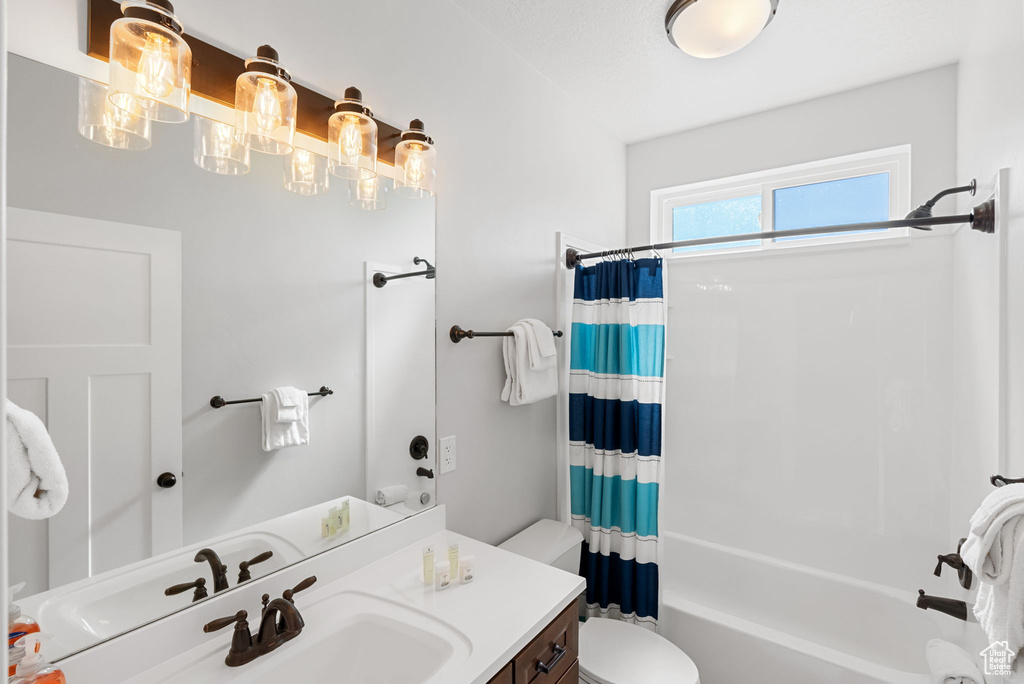 Full bathroom with shower / tub combo, toilet, and vanity