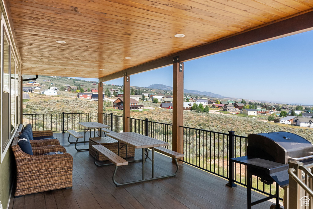 Wooden terrace with a mountain view and a grill