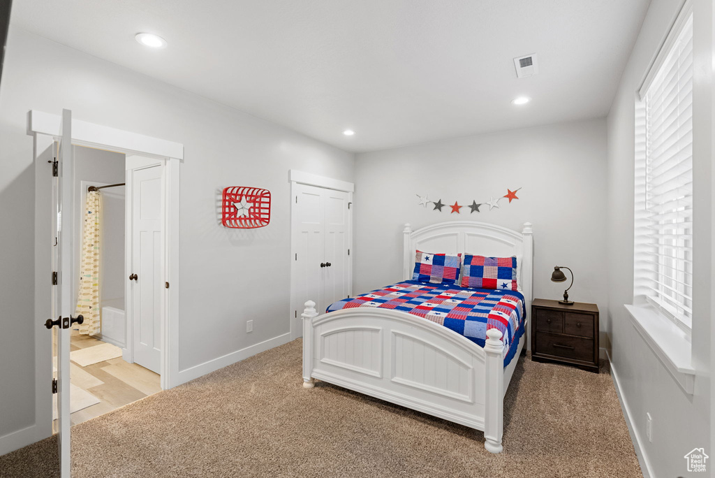 Bedroom with light carpet