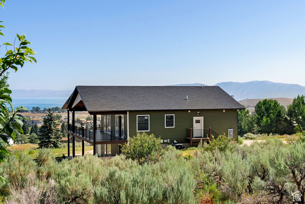 Rear view of house featuring a mountain view