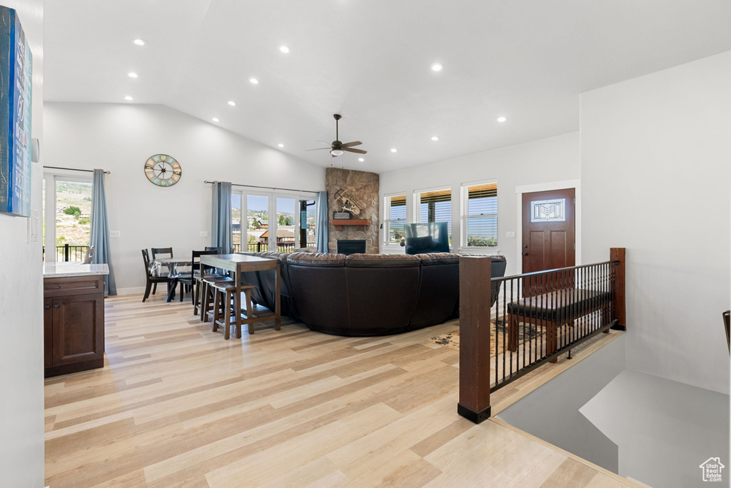 Living room with a healthy amount of sunlight, light hardwood / wood-style floors, and ceiling fan