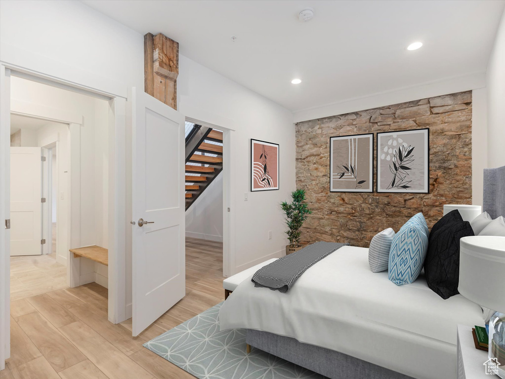 Bedroom with light hardwood / wood-style floors