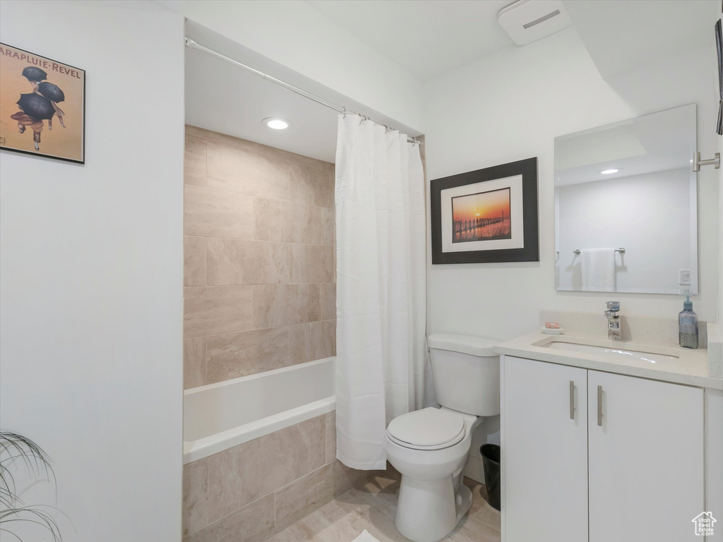 Full bathroom with vanity, tile patterned flooring, toilet, and shower / bath combination with curtain