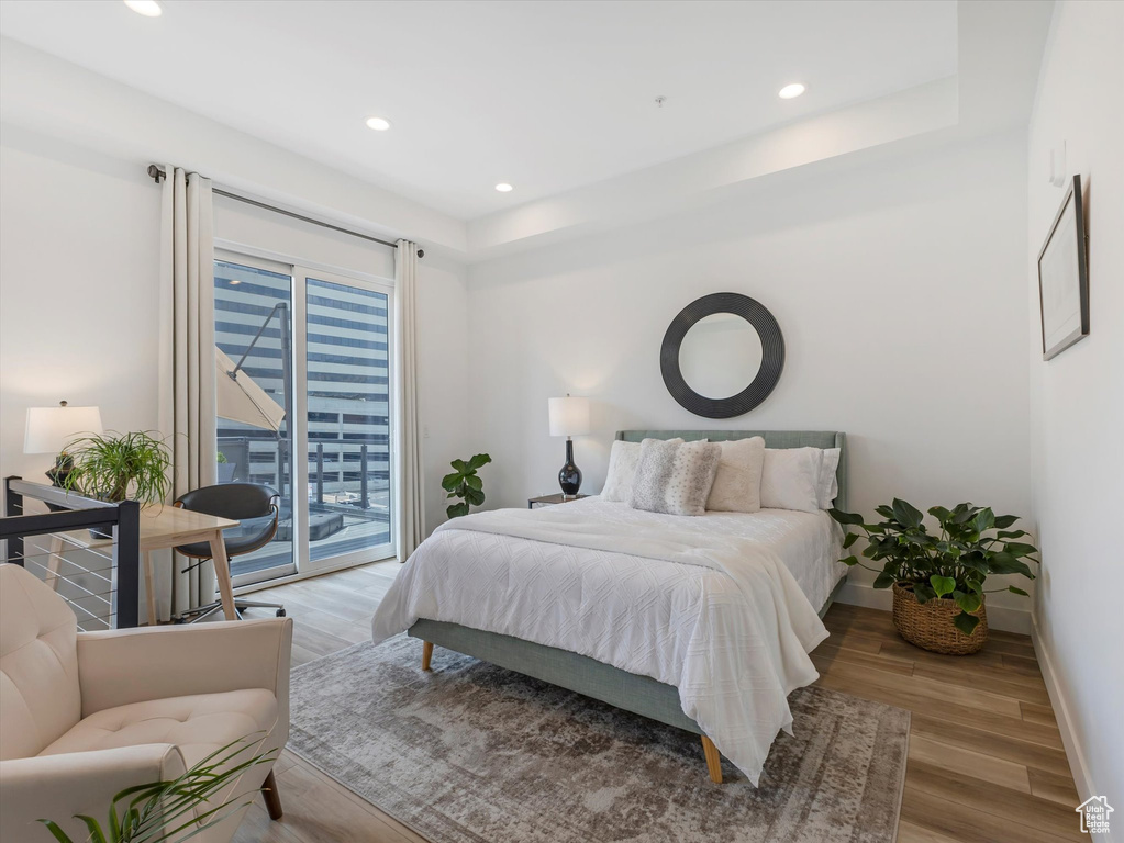 Bedroom featuring light hardwood / wood-style floors and access to outside