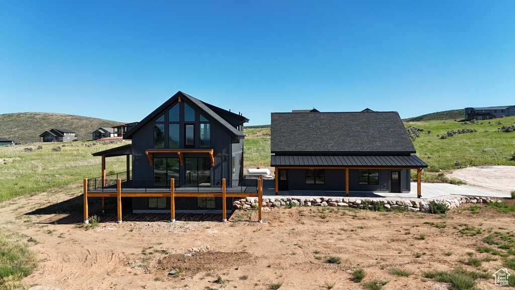 Rear view of property featuring a deck with mountain view