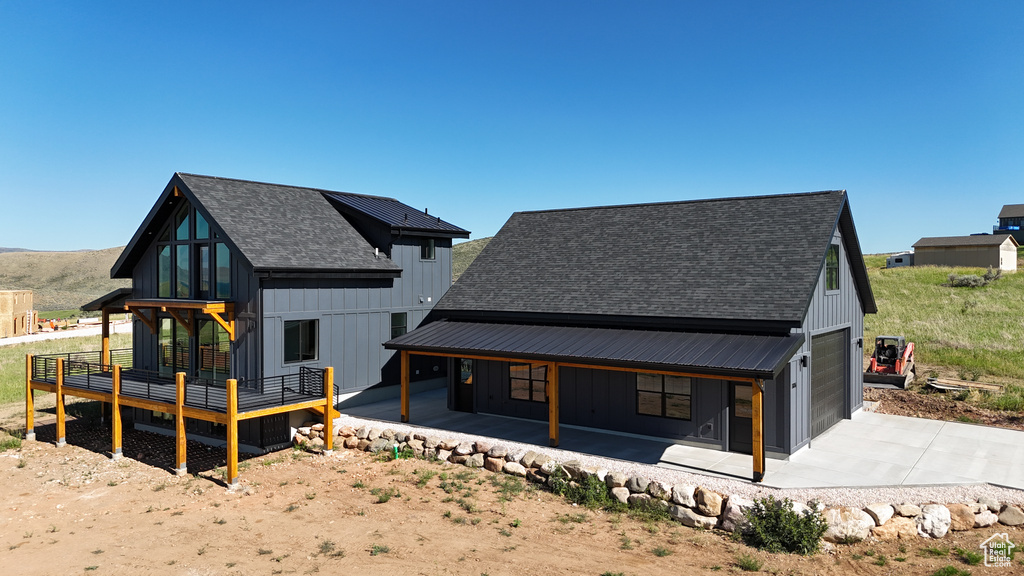 Rear view of house featuring a porch