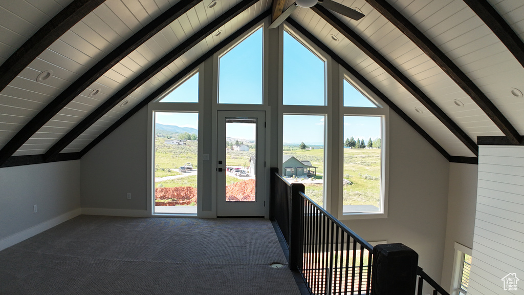 Bonus room with high vaulted ceiling, beamed ceiling, carpet, and a healthy amount of sunlight