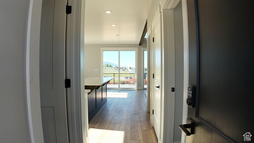 Corridor with light hardwood / wood-style floors