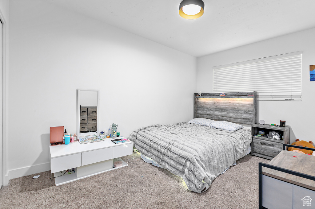 Bedroom featuring light colored carpet