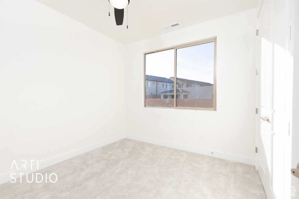 Spare room with light carpet and ceiling fan