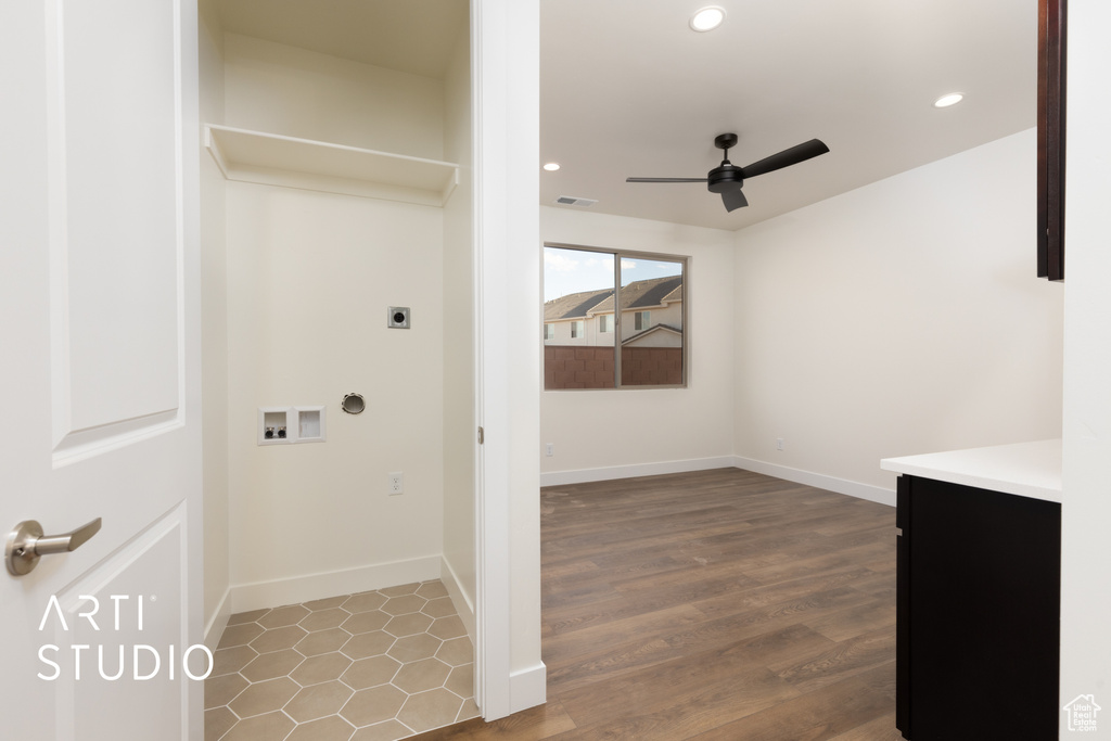 Laundry area with hookup for an electric dryer, hardwood / wood-style floors, hookup for a washing machine, and ceiling fan