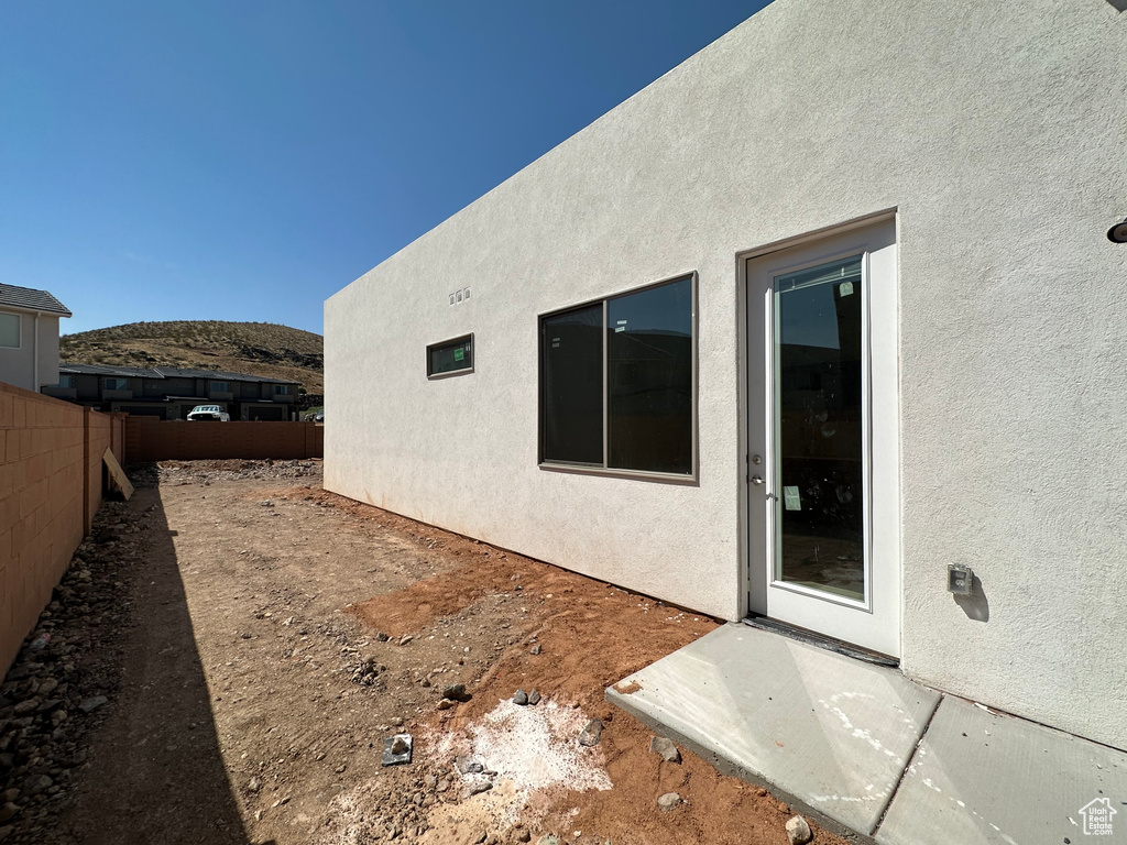 View of side of home with a mountain view