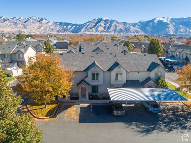 Rear view of property with a mountain view and a carport