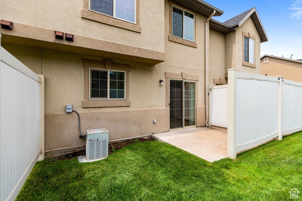 Back of house featuring a patio area and a lawn