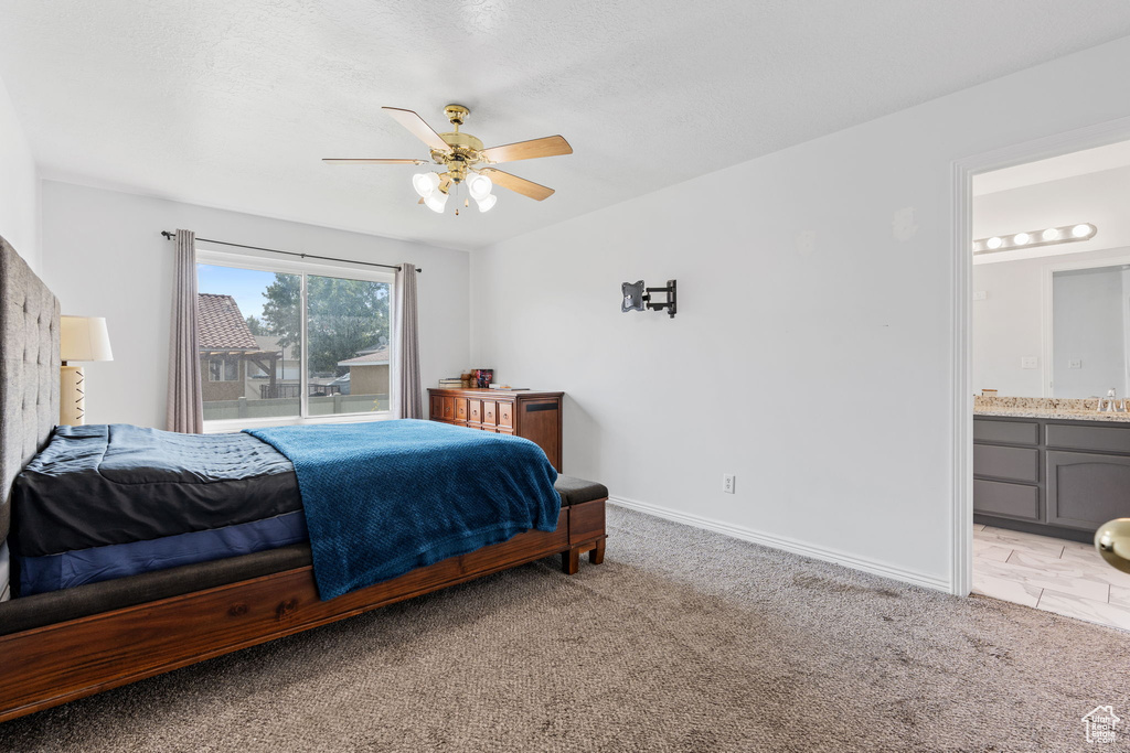 Tiled bedroom featuring sink, connected bathroom, and ceiling fan