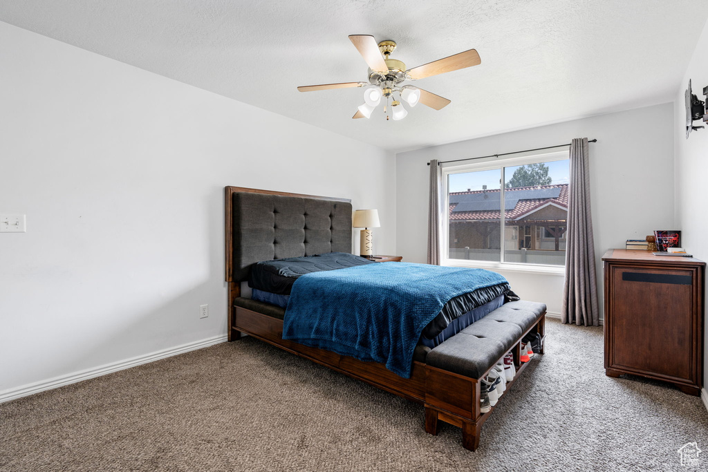 Carpeted bedroom with ceiling fan