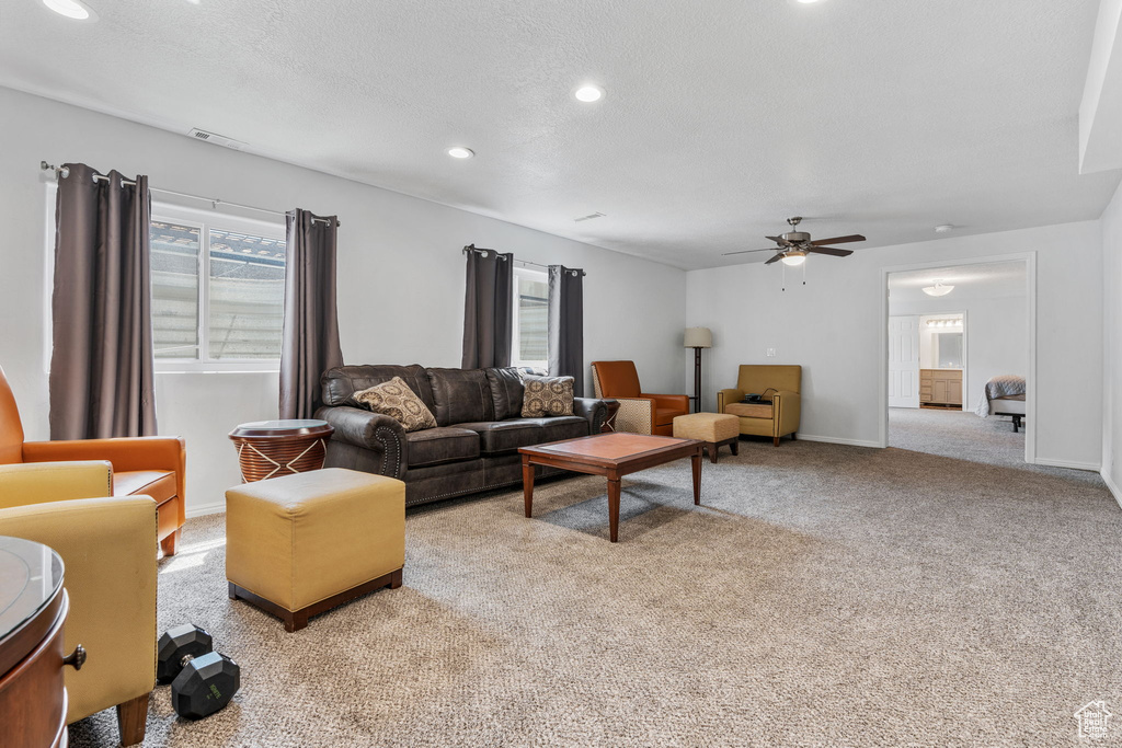 Living room featuring ceiling fan and light colored carpet