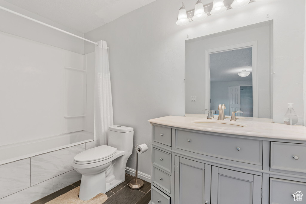 Bathroom featuring vanity, tile patterned flooring, and toilet