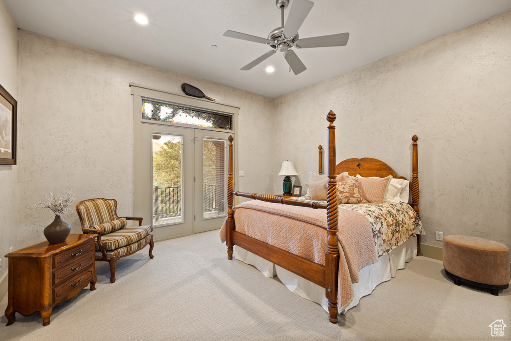 Bedroom featuring access to exterior, light carpet, ceiling fan, and french doors