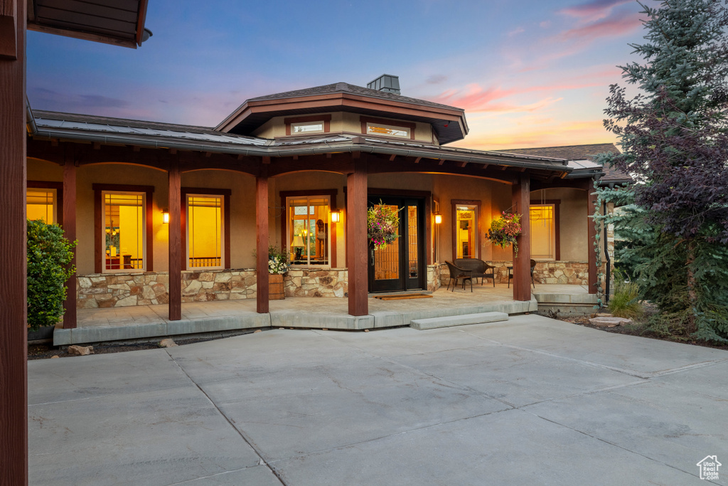 Back house at dusk with a patio area