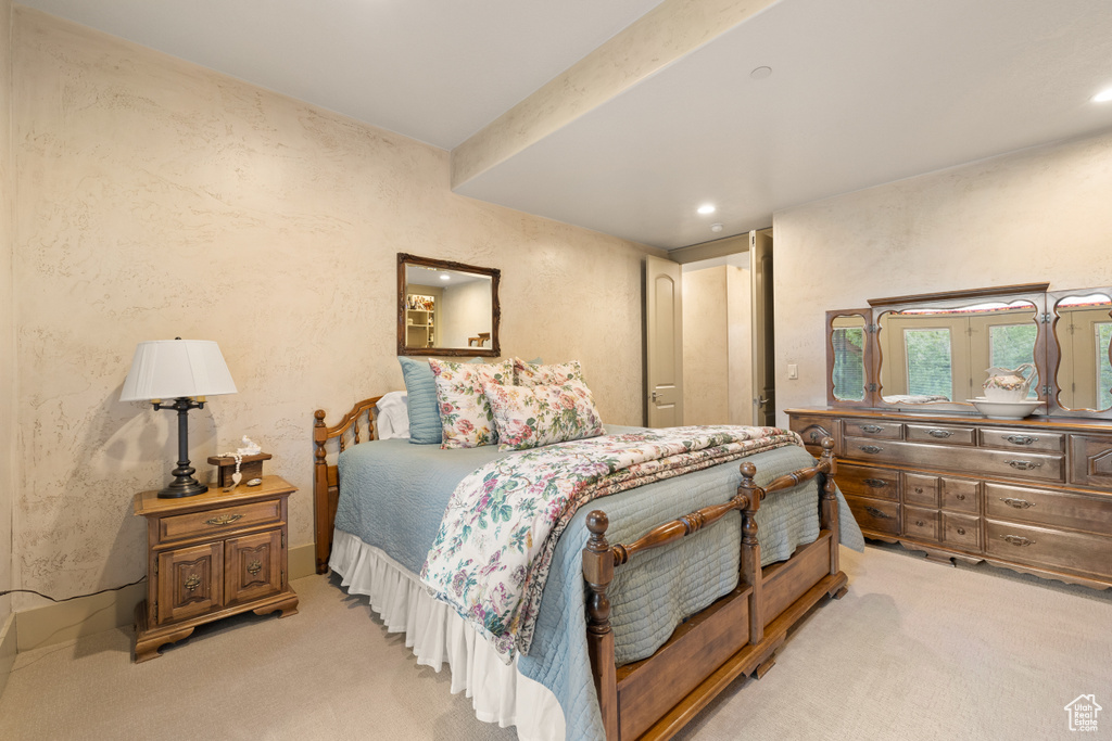 Bedroom with light colored carpet