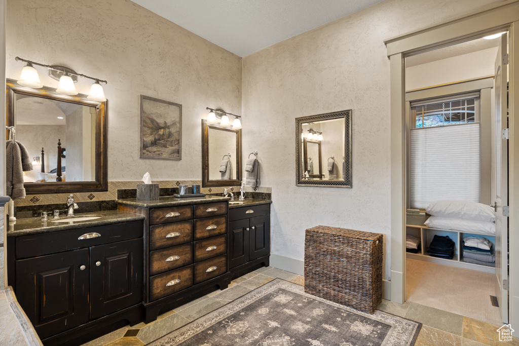 Bathroom with double vanity and tile patterned flooring