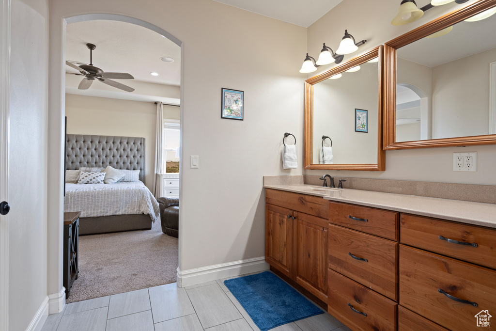 Bathroom with tile patterned flooring, vanity, and ceiling fan