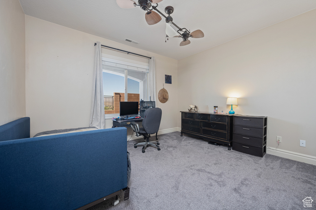 Carpeted home office with ceiling fan