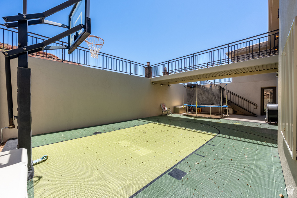 View of basketball court featuring a trampoline