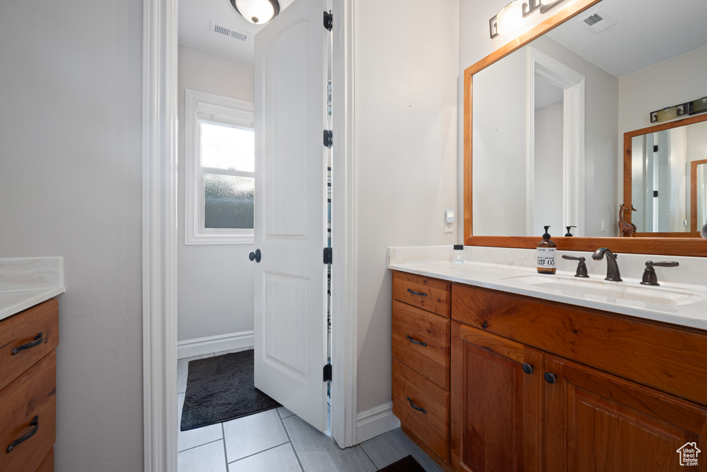 Bathroom featuring vanity and tile patterned floors