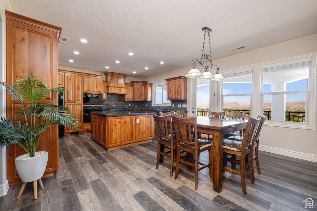 Dining room with dark hardwood / wood-style flooring