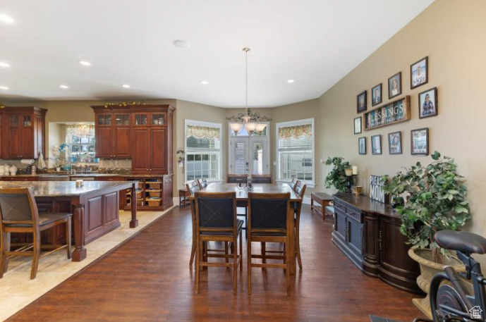 Dining area featuring a notable chandelier, french doors, and dark hardwood / wood-style flooring