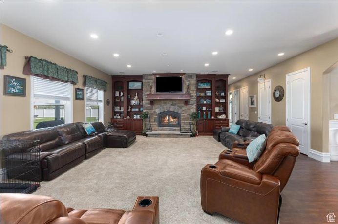 Living room with a fireplace and hardwood / wood-style floors