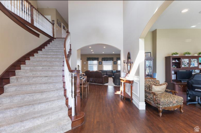 Entrance foyer with a high ceiling and hardwood / wood-style floors