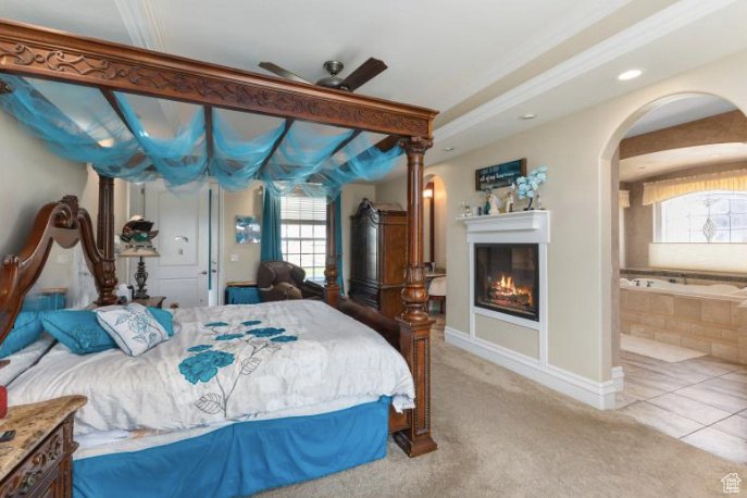 Bedroom featuring light tile patterned floors and ceiling fan