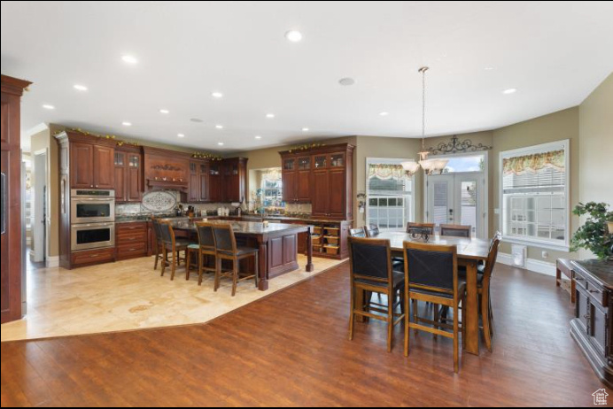 Tiled dining room with a notable chandelier