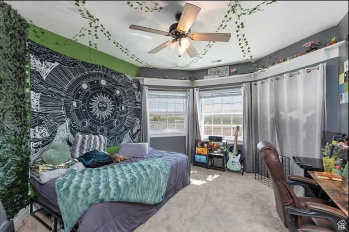 Bedroom with light colored carpet and ceiling fan