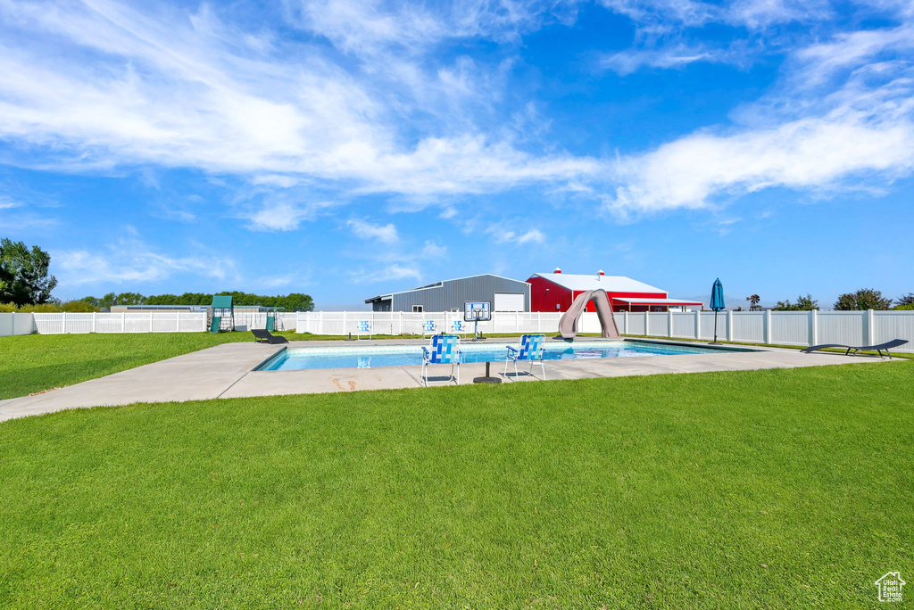 Exterior space featuring a yard and a fenced in pool