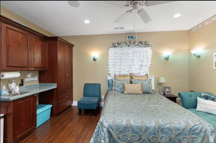 Bedroom featuring ceiling fan and dark hardwood / wood-style flooring