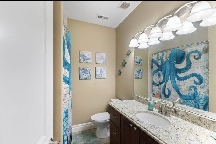 Bathroom with vanity, toilet, and tile patterned flooring