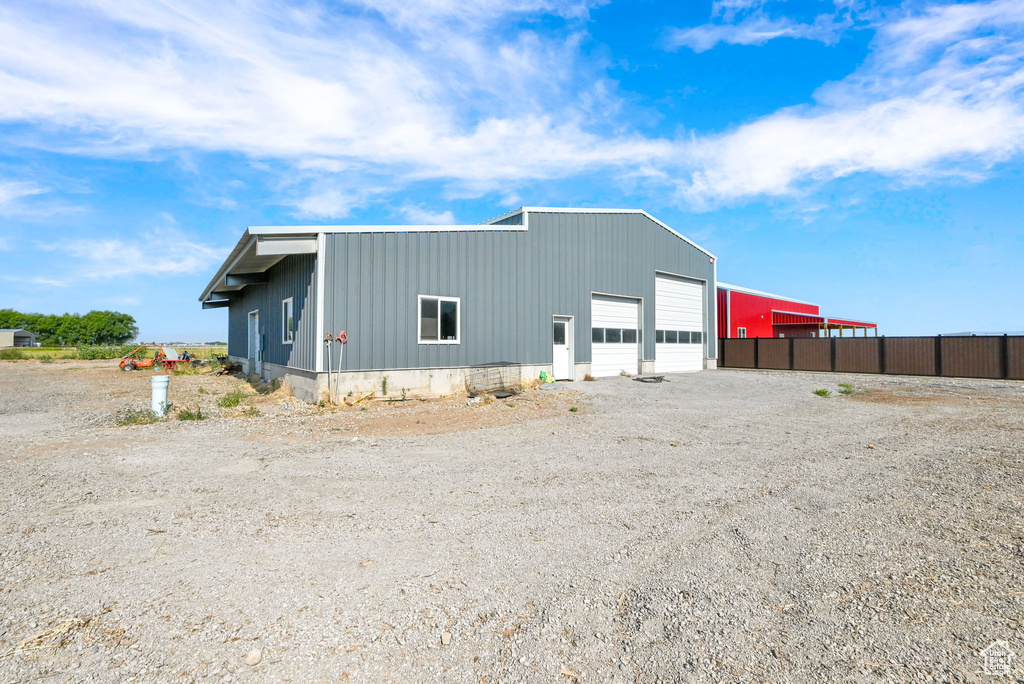 Back of house featuring a garage and an outdoor structure