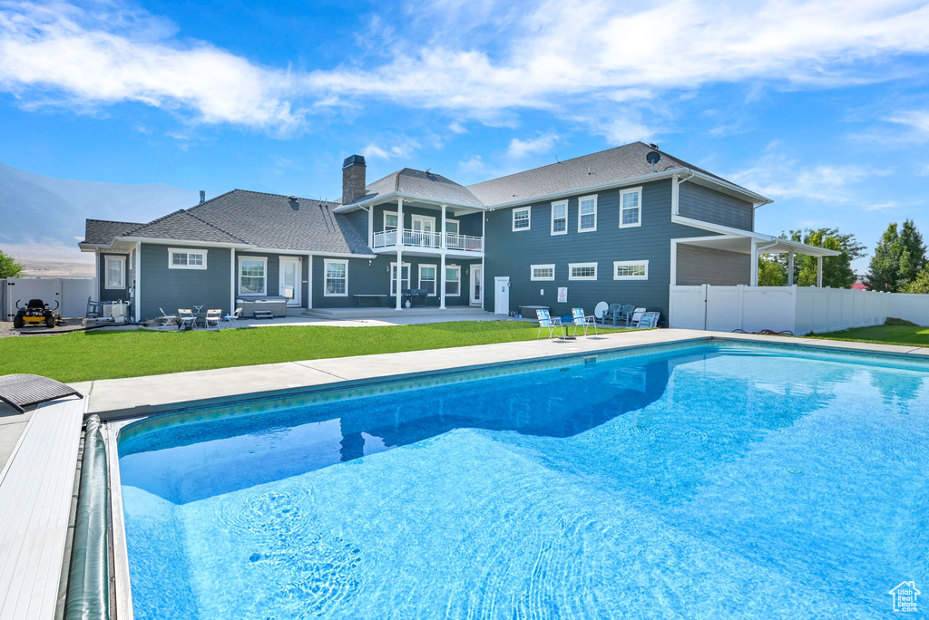 View of pool with a patio and a yard